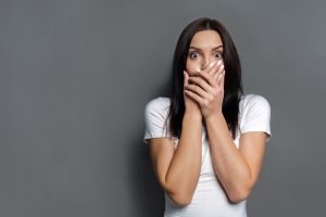 woman-on-grey-background-looking-shocked