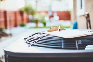 air-conditioning-outside-unit-with-clipboard-sitting-on-top