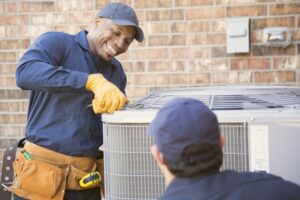 two-technicians-working-on-an-air-conditioner