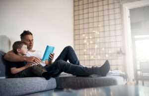 man-and-son-sitting-on-couch-in-living-room