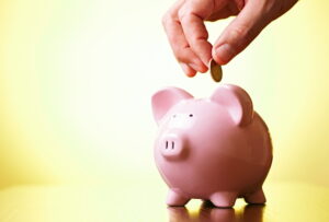 coins-being-dropped-into-a-piggy-bank